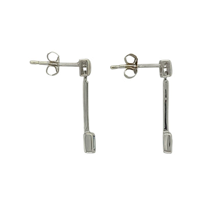 Add a fresh pop of colour and refined elegance to your collection with these pre-owned 9ct white gold blue topaz set drop earrings—an effortlessly stylish pair perfect for any occasion.

Design: The earrings feature a simple drop style, each set with a 3mm by 3mm square blue topaz stone, offering a clean and modern look with a soft blue sparkle.
Material: Made from 9-carat white gold, the polished finish enhances the cool tone of the metal while complementing the brightness of the blue topaz.