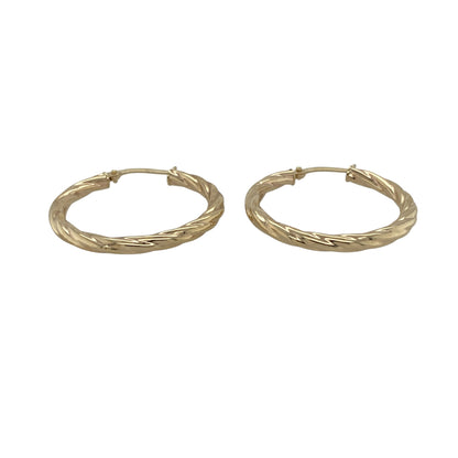 Add classic texture and everyday elegance to your collection with these pre-owned 9ct yellow gold twisted hoop creole earrings—an effortlessly stylish pair with timeless appeal.

Design: The earrings feature a traditional hoop creole shape with a twisted pattern, creating subtle movement and light-catching detail for a refined finish.
Material: Made from 9-carat yellow gold, the polished finish enhances the warmth of the metal while highlighting the twist design.
