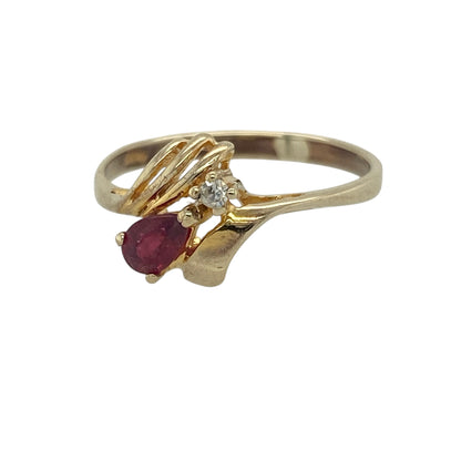 Add graceful movement and rich colour to your collection with this pre-owned 9ct yellow gold diamond and ruby set wrap around teardrop ring—an elegant piece with a delicate and flowing design.

Design: The ring features a 5mm by 3mm teardrop-shaped ruby, complemented by sparkling diamond accents within a wrap around style that creates a soft and fluid look. 