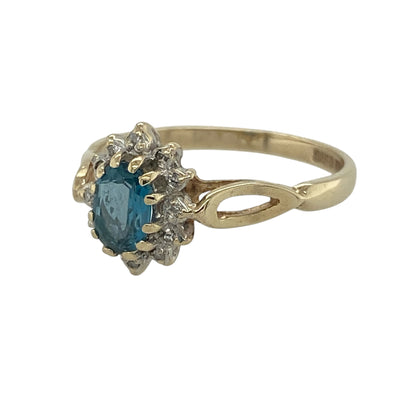 Add a touch of elegance and fresh colour to your collection with this pre-owned 9ct yellow gold diamond and blue topaz set cluster ring—an effortlessly stylish piece with timeless appeal.

Design: The ring features a 6mm by 4mm oval blue topaz centre stone, surrounded by a cluster of sparkling diamonds that enhance its brilliance and create a refined focal point.
