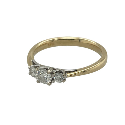 Add timeless elegance and classic sparkle to your collection with this pre-owned 18ct yellow gold diamond set trilogy ring—an enduring design perfect for any occasion.

Design: The ring features three sparkling diamonds arranged in a traditional trilogy style, with approximately 0.30ct total diamond content, creating a balanced and elegant look.
Material: Made from 18-carat yellow gold, the polished finish enhances the richness of the metal while complementing the brilliance of the diamonds.