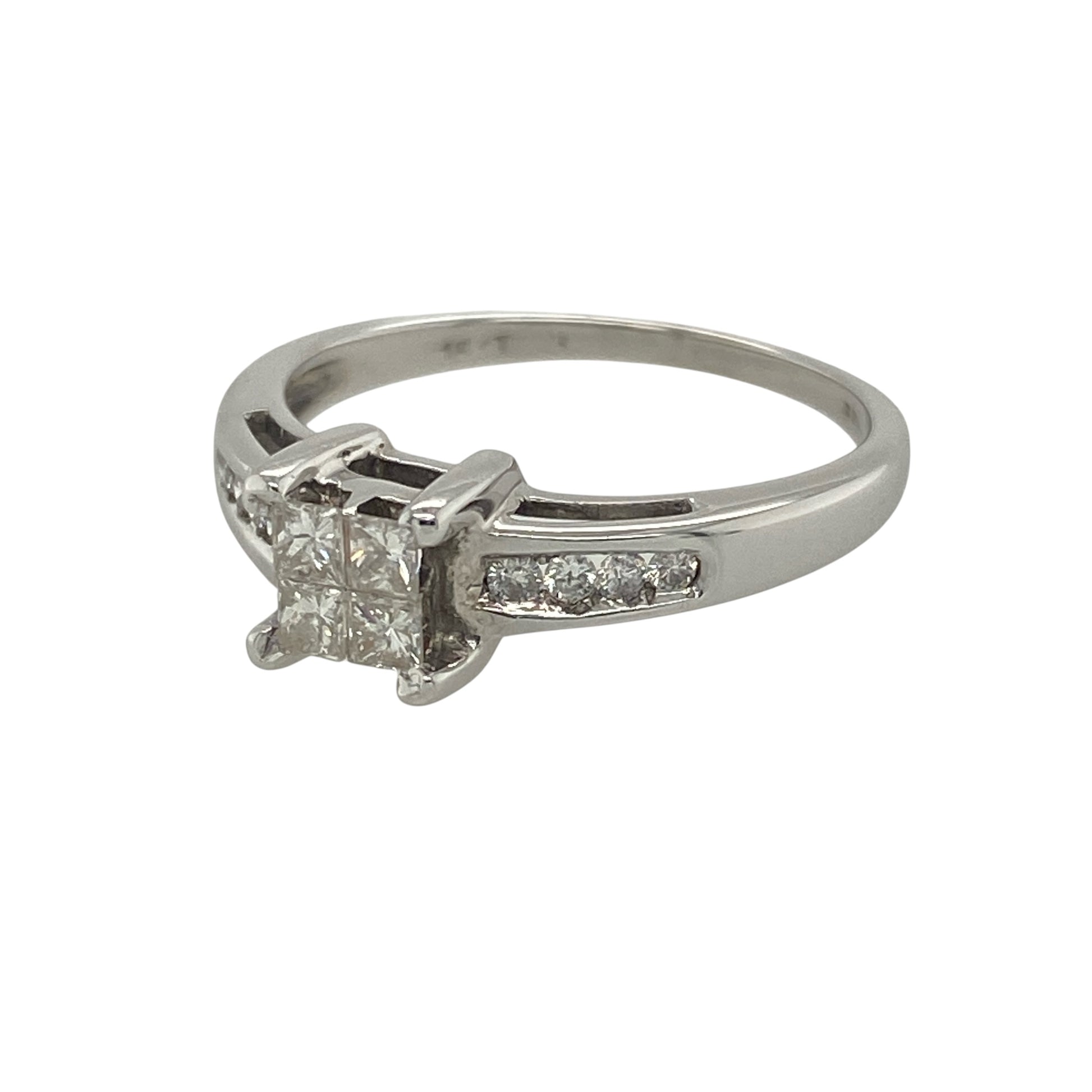 Add striking brilliance and modern elegance to your collection with this pre-owned 18ct white gold diamond illusion set solitaire ring—an eye-catching piece designed to maximise sparkle.

Design: The ring features a centre made up of four princess-cut diamonds, arranged to create the illusion of a single larger stone, with additional diamonds set along the shoulders for enhanced brilliance. The centre stones total approximately 0.24ct, with around 0.40ct total diamond content overall.