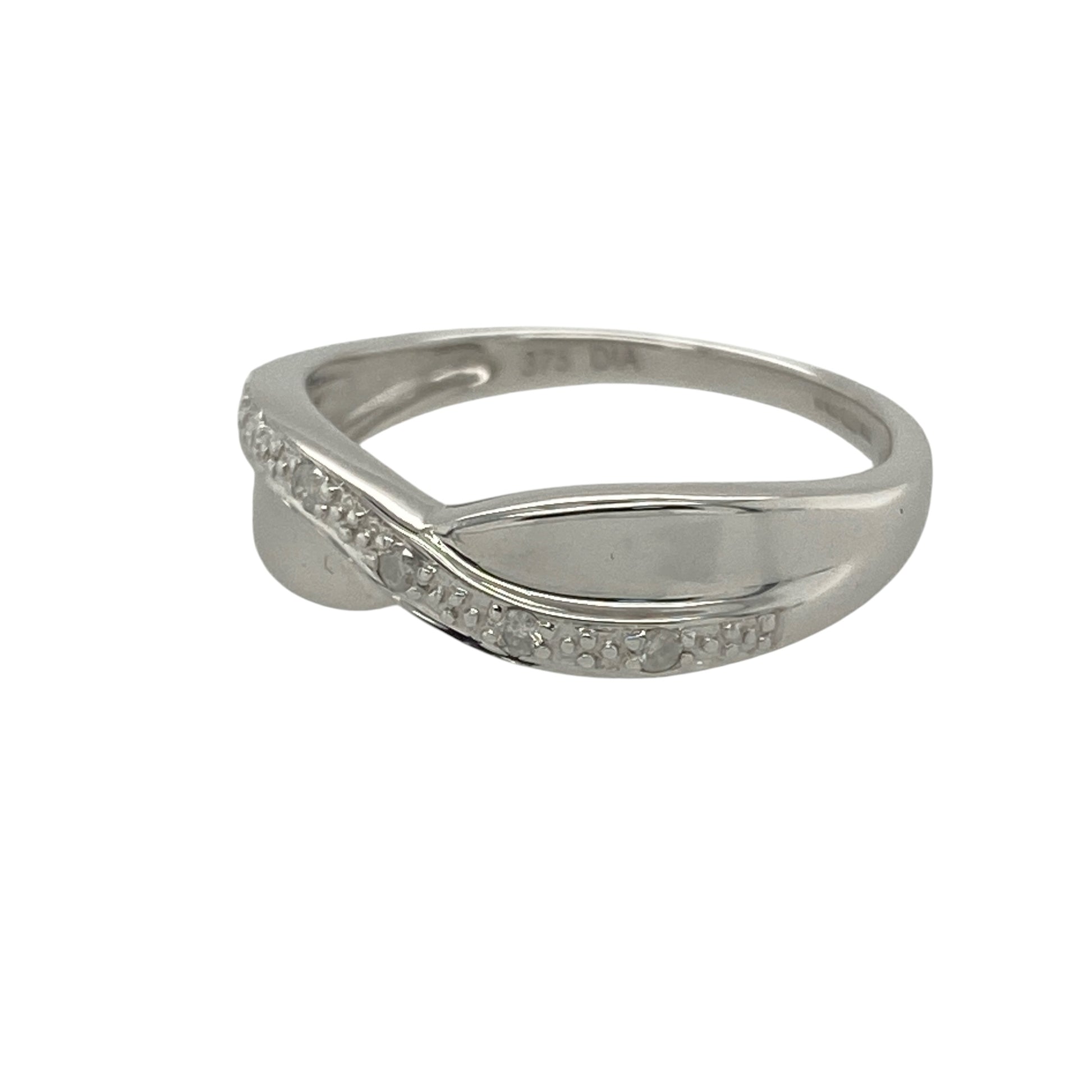 Add modern elegance and refined sparkle to your collection with this pre-owned 18ct white gold diamond set crossover band ring—an effortlessly stylish piece with contemporary appeal.

Design: The ring features a graceful crossover band design, accented with sparkling diamonds that enhance the flowing lines and create a bright, eye-catching finish.
Material: Made from 18-carat white gold, the polished finish enhances the cool tone of the metal while complementing the brilliance of the diamonds.