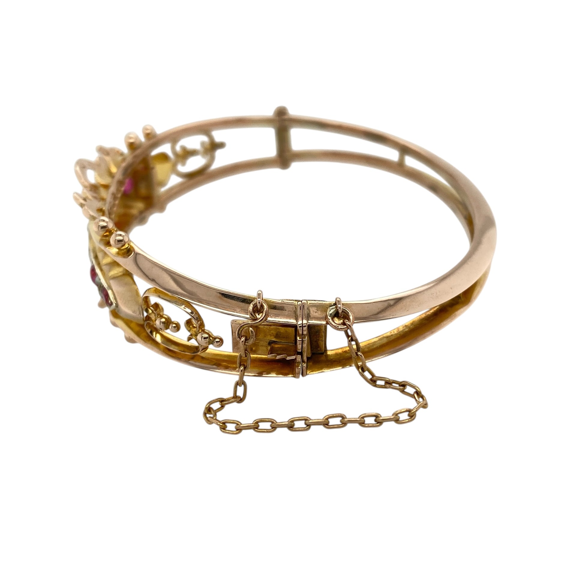 Add vintage elegance and rich colour to your collection with this pre-owned 9ct yellow gold ruby and pearl set bangle—an eye-catching piece with timeless charm.

Design: The bangle features a decorative front measuring approximately 1.8cm, set with vibrant ruby gemstones and soft lustrous pearls, creating a beautiful contrast in a vintage-inspired arrangement.