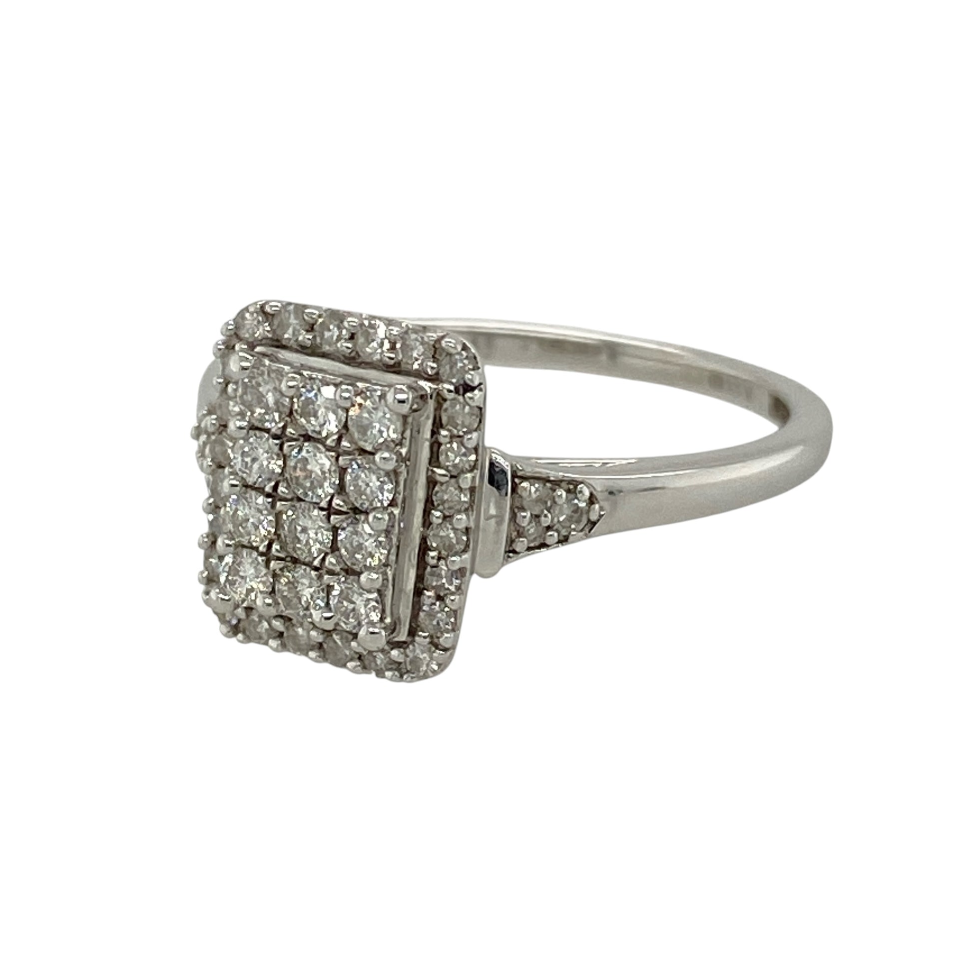 Add bold sparkle and modern elegance to your collection with this pre-owned 9ct white gold diamond set rectangle cluster halo ring—an eye-catching piece with timeless appeal.

Design: The ring features a rectangular cluster halo front measuring approximately 11mm in height, set with a combination of diamonds that create a bright and structured focal point, with approximately 0.36ct of total diamond content for impressive sparkle.