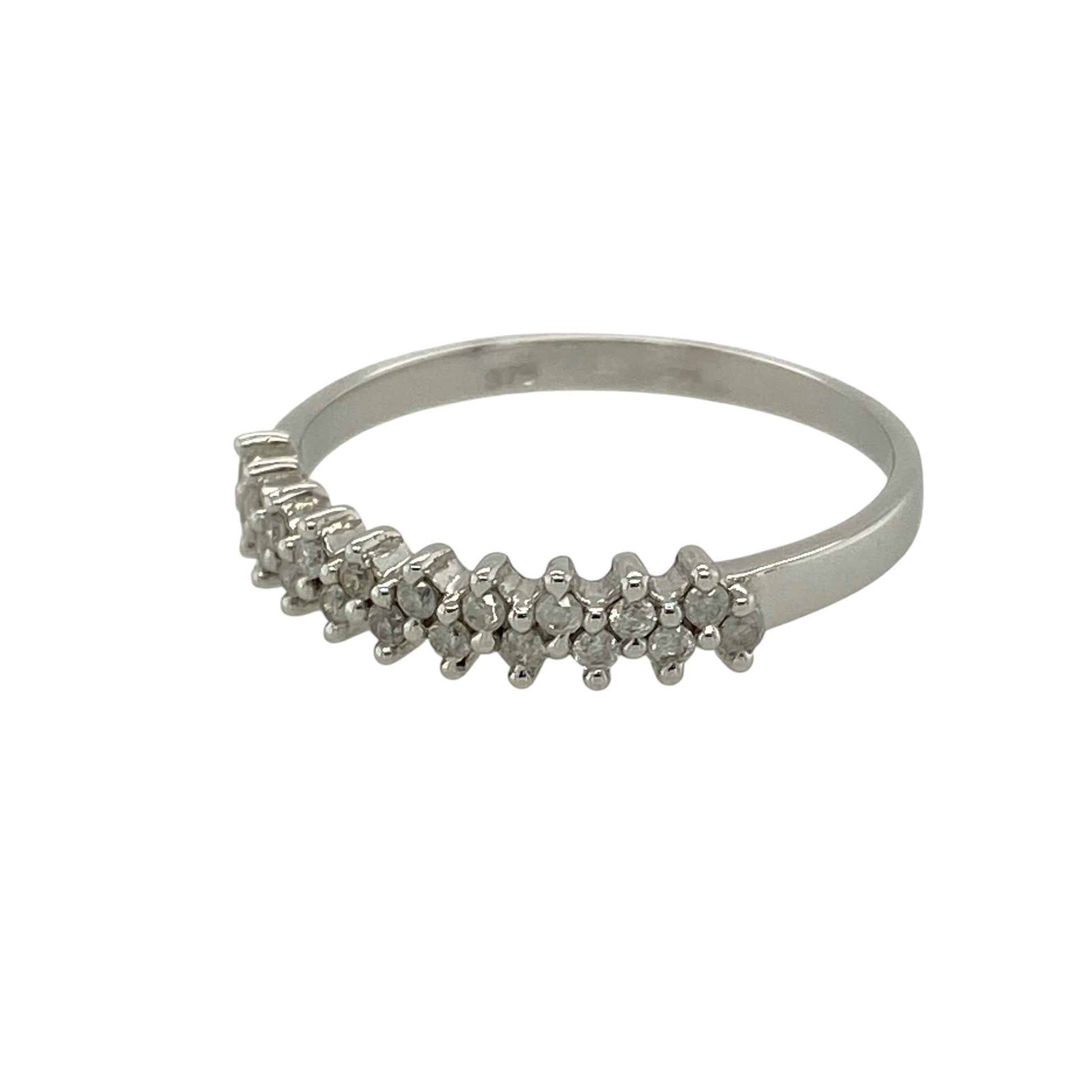 Add refined sparkle and contemporary elegance to your collection with this pre-owned 9ct white gold diamond set two row band ring—an effortlessly stylish piece with timeless appeal.

Design: The ring features a 4mm wide front composed of two rows of sparkling diamonds, with approximately 0.20ct total diamond content, creating a layered and eye-catching look.
Material: Made from 9-carat white gold, the polished finish enhances the cool tone of the metal while complementing the brilliance of the diamonds.