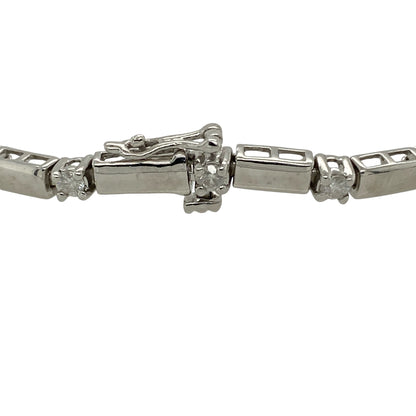Add refined brilliance and timeless elegance to your collection with this pre-owned 9ct white gold diamond set bracelet—an eye-catching piece designed to impress.

Design: The bracelet features nineteen brilliant-cut diamonds set in a linear arrangement, separated by sleek white gold bars that create a clean, structured, and contemporary look. With approximately 0.76ct total diamond content, it offers beautiful, continuous sparkle.