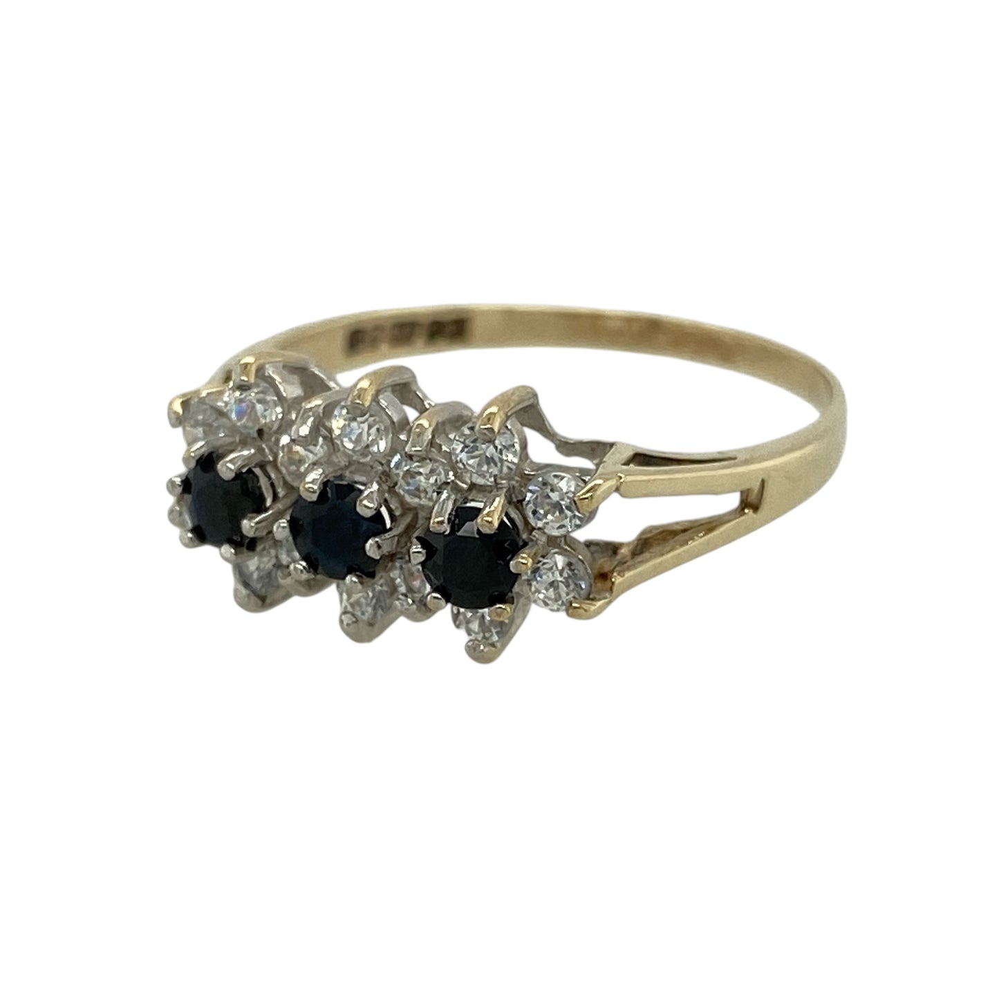 Add a touch of colour and sparkle to your collection with this pre-owned 9ct yellow gold sapphire and cubic zirconia set cluster ring—an elegant piece with timeless appeal.

Design: The ring features a cluster front measuring approximately 8mm, made up of three round sapphires each approximately 3mm in diameter, surrounded by sparkling cubic zirconia that enhance their deep blue tones and create a bright, eye-catching finish.