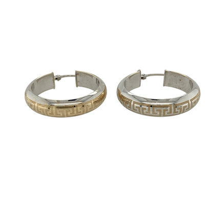 Add timeless pattern and bold elegance to your collection with these pre-owned 9ct white gold with yellow gold detail Greek key hoop creole earrings—an eye-catching pair with classic appeal.

Design: The earrings feature a traditional hoop creole shape with a Greek key pattern detail, creating a distinctive and structured design inspired by timeless motifs.