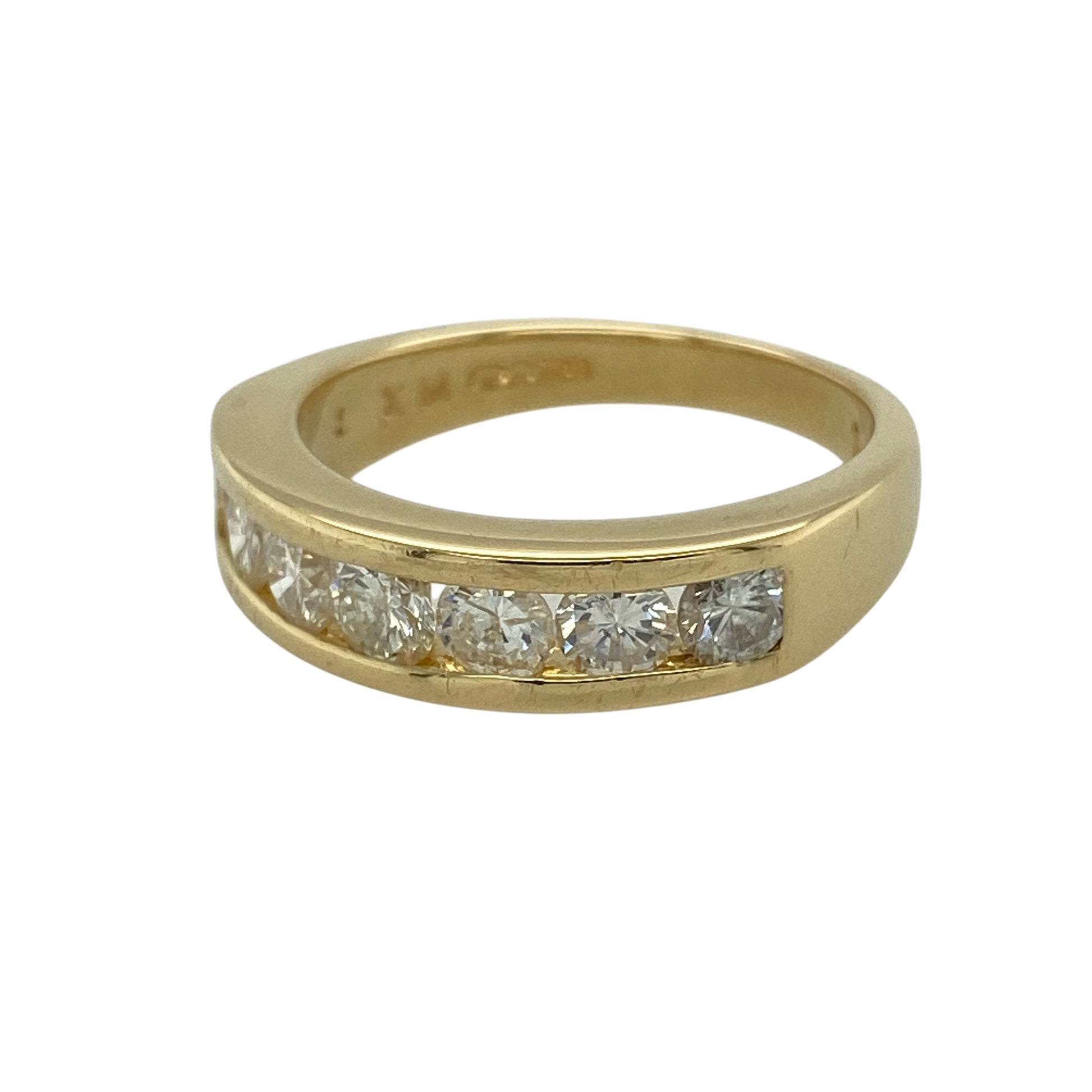 Add bold sparkle and timeless elegance to your collection with this pre-owned 18ct yellow gold diamond set seven stone band ring—an eye-catching piece with classic appeal.

Design: The ring features a 5mm wide band at the front, set with seven diamonds arranged in a balanced row, creating a bright and continuous display of sparkle.
Material: Made from 18-carat yellow gold, the polished finish enhances the rich warmth of the metal while complementing the brilliance of the diamonds.