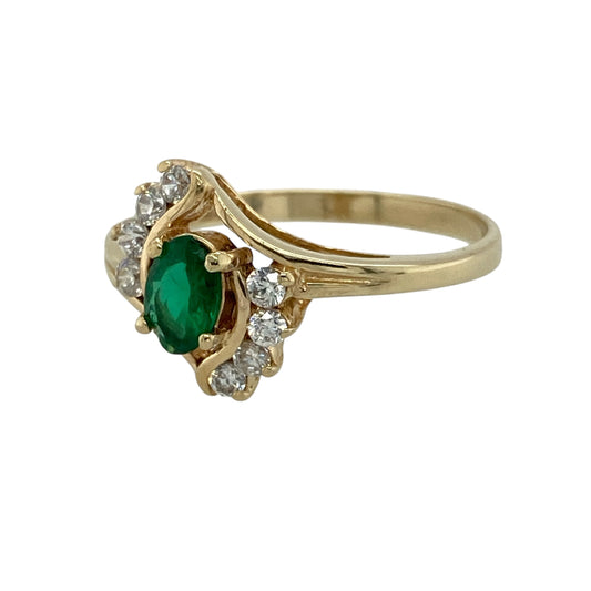 Add bold colour and elegant sparkle to your collection with this pre-owned 14ct yellow gold green stone and cubic zirconia set ring—an eye-catching piece with timeless appeal.

Design: The ring features a striking front measuring approximately 13mm in height, centred with a 6mm by 4mm oval emerald-coloured green stone, surrounded by sparkling cubic zirconia that enhance its vibrant tone.