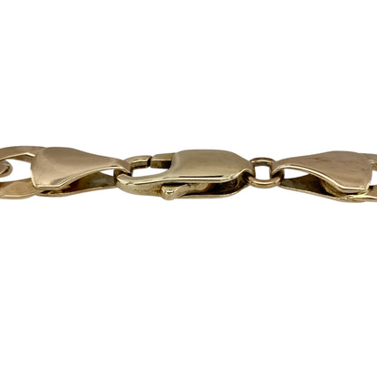 Make a bold and powerful statement with this pre-owned 9ct yellow gold curb bracelet—an eye-catching piece with timeless strength and classic appeal.

Design: The bracelet features a substantial 9mm wide curb link design, creating a strong and structured look with smooth, interlocking links that sit comfortably on the wrist.
Material: Made from 9-carat yellow gold, the polished finish enhances the rich, warm tone of the metal while adding a bright, reflective shine.