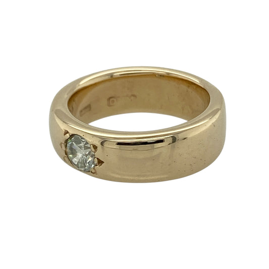 Add bold elegance and refined sparkle to your collection with this pre-owned 9ct yellow gold diamond set solitaire band ring—an eye-catching piece with timeless appeal.

Design: The ring features a substantial 6mm wide band, set with a single brilliant-cut diamond of approximately 0.28ct, creating a striking focal point against the smooth gold surface.
Material: Made from 9-carat yellow gold, the polished finish enhances the rich warmth of the metal while complementing the brilliance of the diamond.