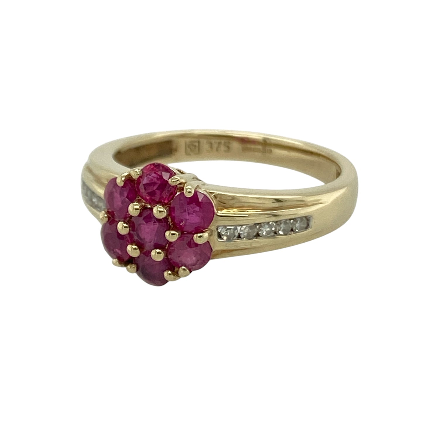 Add rich colour and elegant sparkle to your collection with this pre-owned 9ct yellow gold diamond and ruby set cluster ring—an eye-catching piece with timeless appeal.

Design: The ring features a cluster front measuring approximately 9mm in height, made up of vibrant rubies at the centre, with sparkling diamonds set along the shoulders to enhance the overall brilliance.