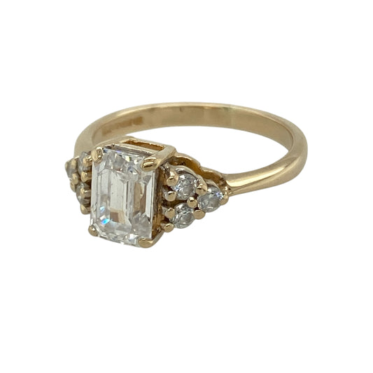 Bring classic sparkle and elegant styling to your collection with this pre-owned 9ct yellow gold cubic zirconia ring, featuring a striking rectangular centre stone and shimmering accents—perfect for both everyday wear and special occasions.

Design: The ring showcases a 7mm by 5mm rectangular cubic zirconia at the centre, flanked by round cubic zirconia stones on either side, creating a balanced and eye-catching three-stone design.