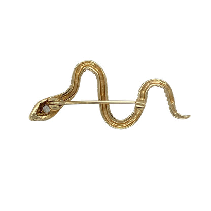 Bring distinctive style and symbolic charm to your collection with this pre-owned 9ct yellow gold ruby and cubic zirconia snake brooch, featuring eye-catching detail and elegant sparkle—perfect for adding character to any outfit.

Design: The brooch features a sleek snake design, with shimmering cubic zirconia stones accenting the head and vivid ruby eyes, creating a striking and lifelike appearance.
