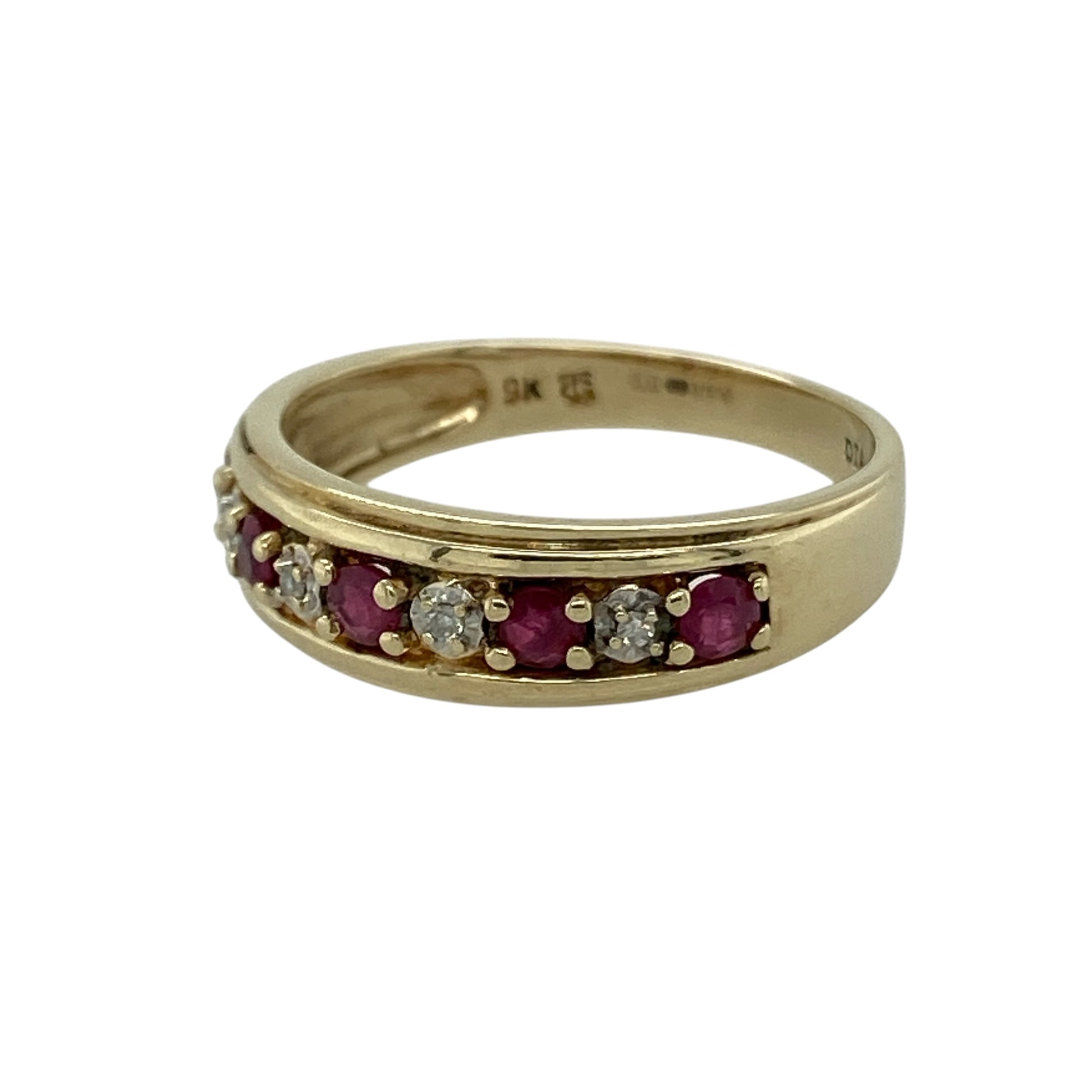 Bring classic colour and refined sparkle to your collection with this pre-owned 9ct yellow gold diamond and ruby set band ring, featuring a balanced design and timeless appeal—perfect for everyday wear or special occasions.

Design: The ring features a band style with a front width of approximately 6mm, set with alternating diamonds and rubies to create a harmonious blend of sparkle and rich colour.