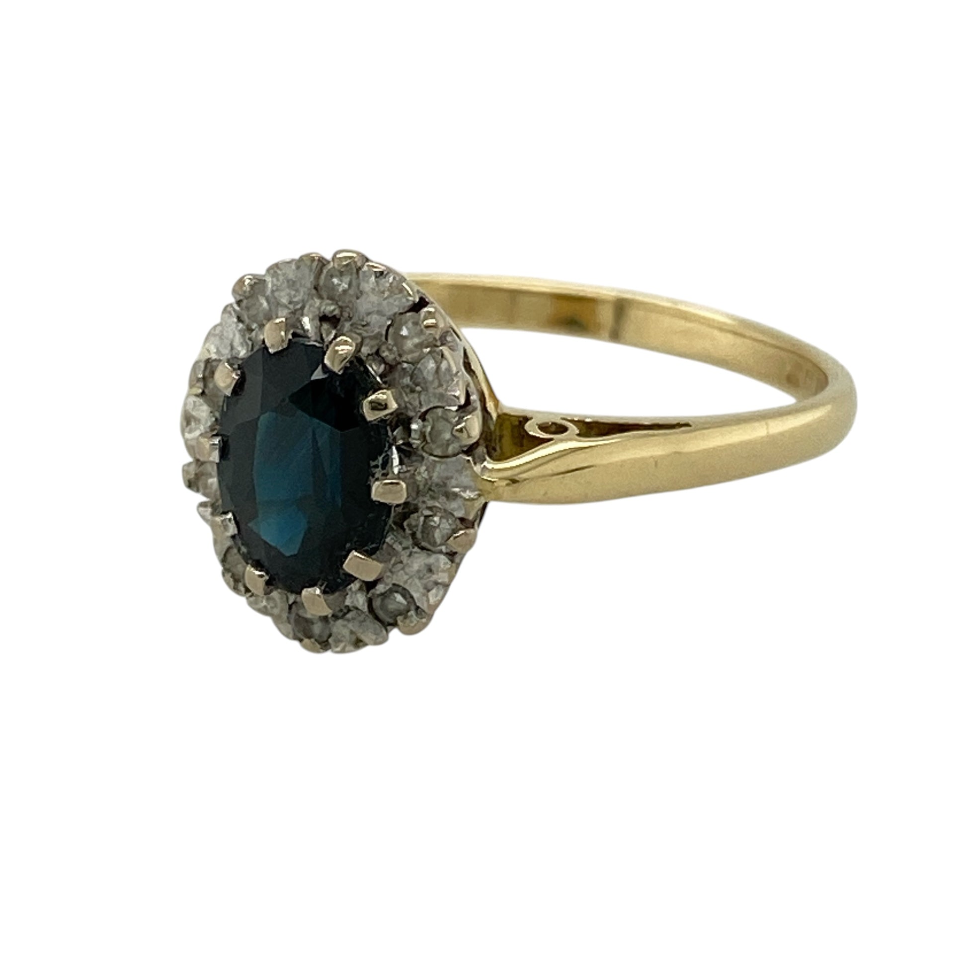 Bring timeless elegance and rich colour to your collection with this pre-owned 18ct yellow gold diamond and sapphire cluster ring, featuring a classic oval centre and refined sparkle—perfect for special occasions or everyday luxury.

Design: The ring showcases a 7mm by 5mm oval sapphire at the centre, surrounded by sparkling diamonds in a traditional cluster formation, creating a balanced and eye-catching look.