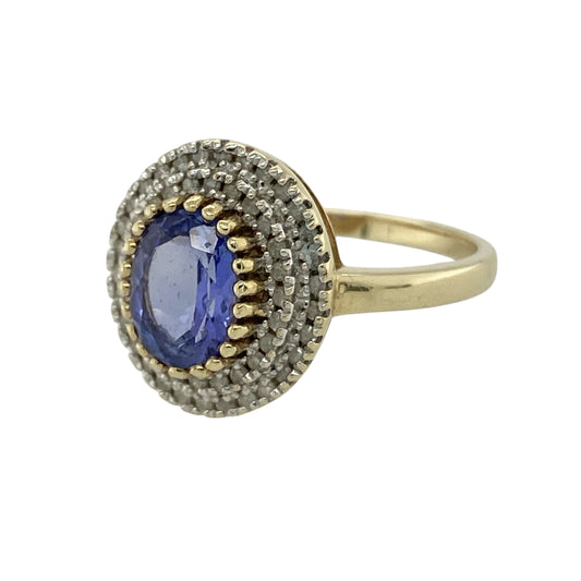Bring vibrant colour and luxurious sparkle to your collection with this pre-owned 9ct yellow gold diamond and tanzanite cluster ring, featuring a striking centre stone and layered brilliance—perfect for special occasions or standout everyday wear.

Design: The ring showcases an 8mm by 6mm oval tanzanite at the centre, surrounded by two rows of sparkling diamonds, creating a bold and eye-catching cluster design with impressive depth.