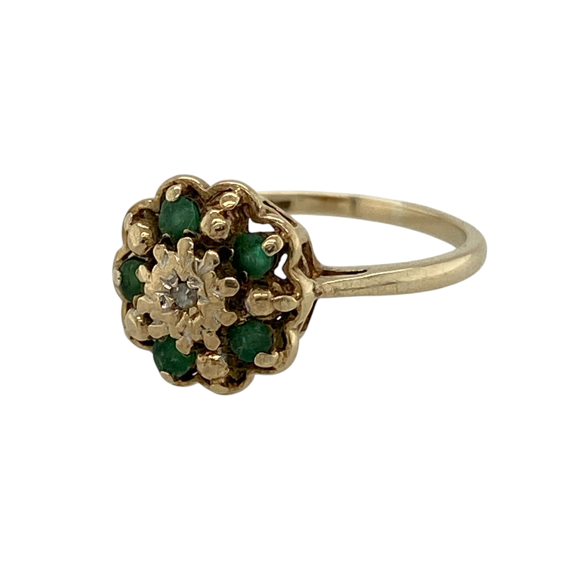 Bring delicate charm and vibrant colour to your collection with this pre-owned 9ct yellow gold diamond and emerald flower cluster ring, featuring a pretty floral design and subtle sparkle—perfect for everyday wear or a thoughtful gift.

Design: The ring showcases a flower-inspired cluster design measuring approximately 9mm in height, set with rich green emeralds and sparkling diamonds to create a soft and eye-catching look.
