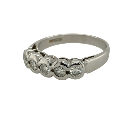 Bring modern elegance and smooth, refined sparkle to your collection with this pre-owned 9ct white gold diamond rubover set five stone band ring, featuring a sleek design with timeless appeal—perfect for everyday wear or special occasions.

Design: The ring features five diamonds arranged across the front in a rubover style, with a band width of approximately 5mm, creating a clean and contemporary look with balanced sparkle.