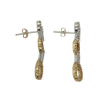 Bring elegant movement and subtle sparkle to your collection with these pre-owned 9ct yellow and white gold diamond set oval link drop earrings, featuring a stylish two-tone design and timeless appeal—perfect for both everyday wear and special occasions.

Design: The earrings feature an oval link drop style, combining smooth, flowing shapes with delicate diamond accents to create a refined and eye-catching look.