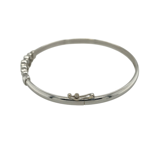 Bring contemporary sparkle and playful design to your collection with this pre-owned 9ct white gold cubic zirconia rubover set bubble style bangle, featuring a modern look with eye-catching detail—perfect for everyday wear or special occasions.

Design: The bangle features a bubble-style front measuring approximately 6mm in height, set with cubic zirconia in a smooth rubover design, creating a sleek and modern appearance with subtle sparkle.