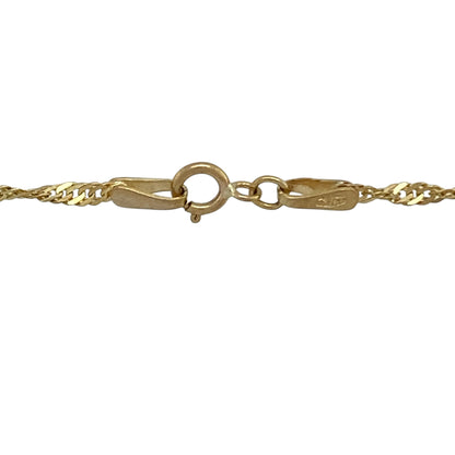 Bring delicate shine and elegant movement to your collection with this pre-owned 9ct yellow gold Singapore chain, featuring a fine twisted design with timeless appeal—perfect for everyday wear or layering.

Design: The chain features a classic Singapore link pattern with a slim 2mm width, offering a graceful twisted design that reflects light beautifully.
Material: Made from 9-carat yellow gold, the polished finish enhances the fluid structure of the links, creating a warm and radiant appearance.