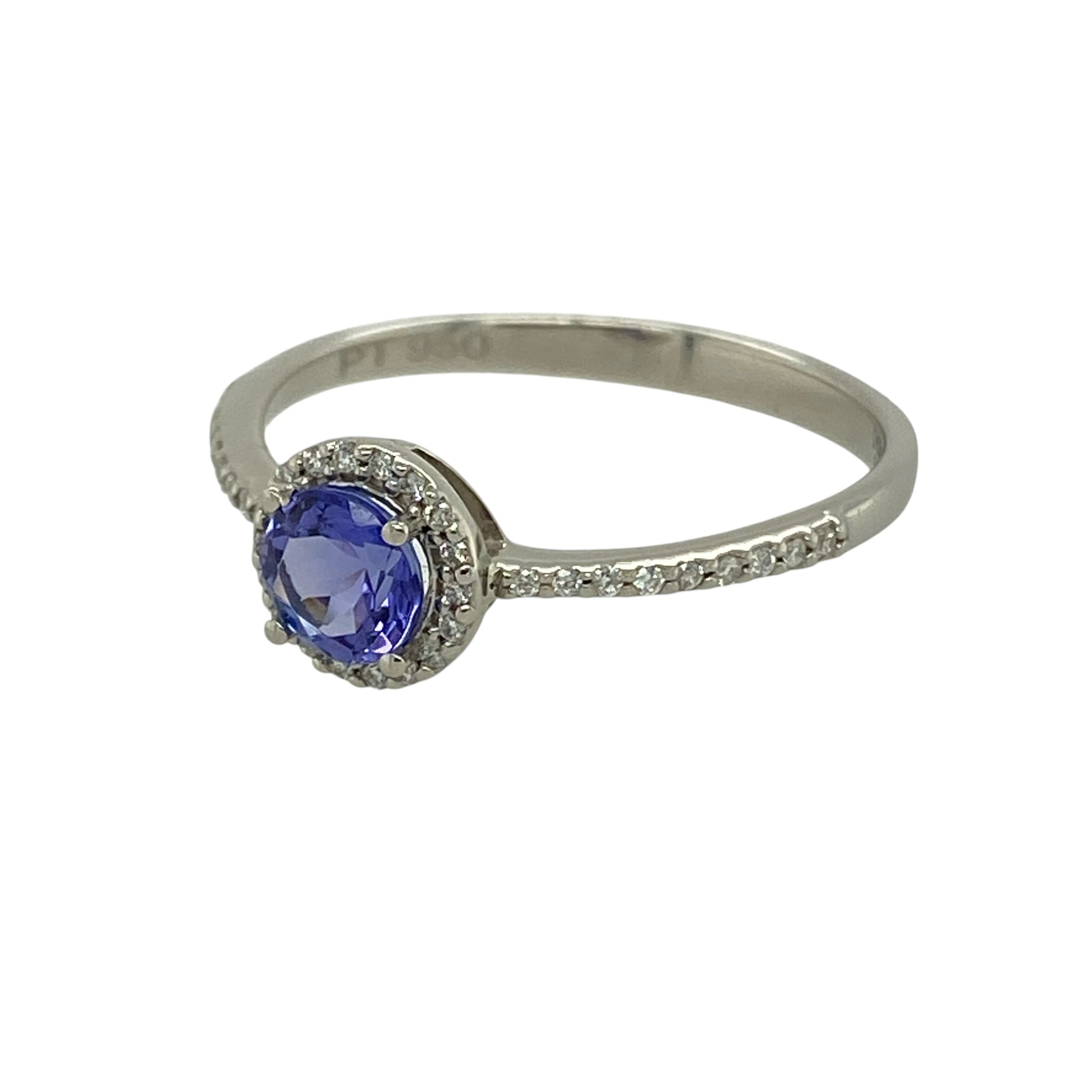 Bring vibrant colour and refined sparkle to your collection with this pre-owned platinum diamond and tanzanite halo ring, featuring a striking centre stone with elegant brilliance—perfect for special occasions or everyday luxury.

Design: The ring showcases a 5mm round tanzanite at the centre, surrounded by a halo of sparkling diamonds, creating a bright and eye-catching focal point.