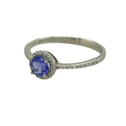 Bring vibrant colour and refined sparkle to your collection with this pre-owned platinum diamond and tanzanite halo ring, featuring a striking centre stone with elegant brilliance—perfect for special occasions or everyday luxury.

Design: The ring showcases a 5mm round tanzanite at the centre, surrounded by a halo of sparkling diamonds, creating a bright and eye-catching focal point.
