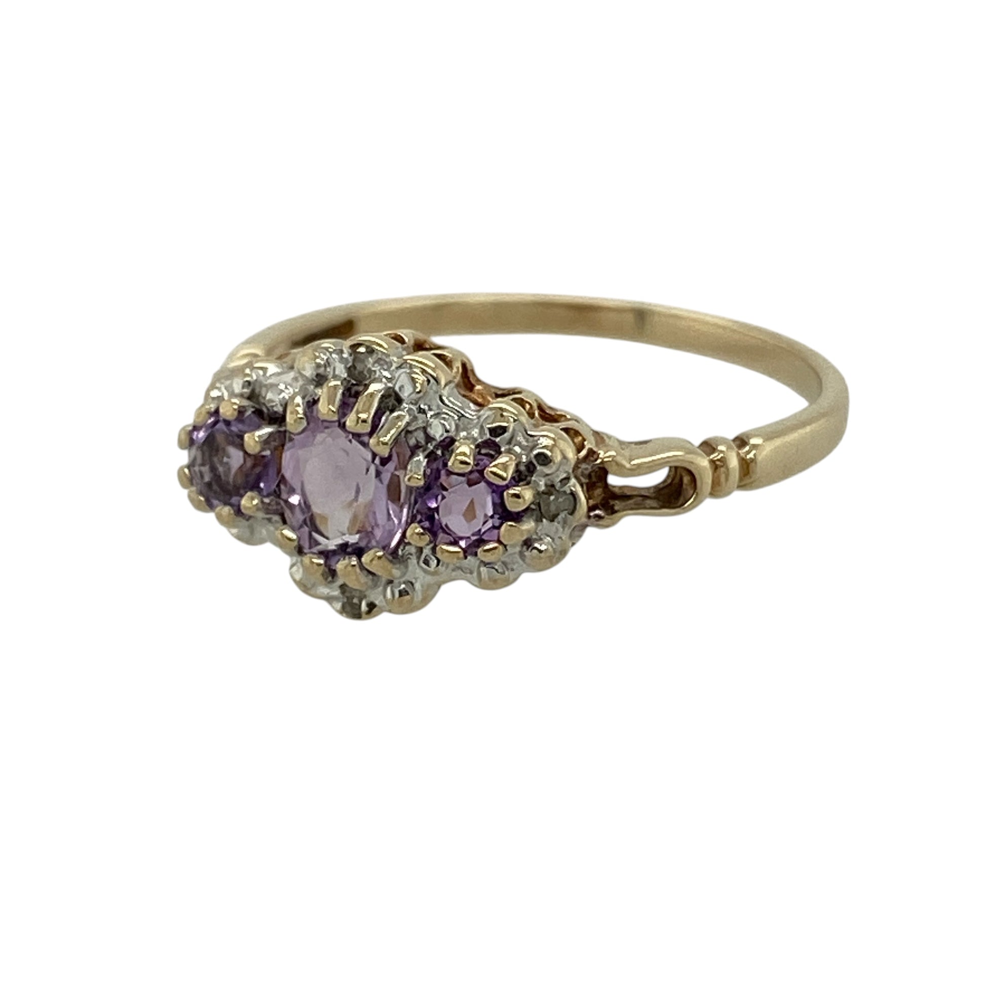 Bring rich colour and elegant sparkle to your collection with this pre-owned 9ct yellow gold diamond and amethyst trilogy cluster ring, featuring a classic design with eye-catching detail—perfect for everyday wear or special occasions.

Design: The ring showcases a 5mm by 4mm oval amethyst at the centre, flanked by two round amethysts measuring approximately 3mm each, all surrounded by sparkling diamonds to create a refined trilogy cluster effect.