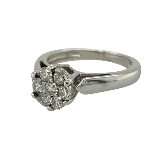 Bring timeless sparkle and floral elegance to your collection with this pre-owned 18ct white gold diamond illusion set solitaire flower cluster ring, featuring a striking design with luxurious brilliance—perfect for special occasions or standout everyday wear.

Design: The ring showcases a flower-inspired cluster design measuring approximately 8mm in height, with illusion-set diamonds arranged to create the appearance of a larger solitaire-style centrepiece with added sparkle.