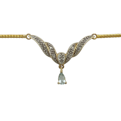 Bring elegant colour and graceful styling to your collection with this pre-owned 9ct yellow and white gold diamond and aquamarine-coloured blue stone necklace, featuring a sophisticated Y-shaped design with delicate sparkle—perfect for special occasions or refined everyday wear.

Design: The necklace features a Y-shaped drop design set with sparkling diamonds and a teardrop-shaped aquamarine-coloured blue stone measuring approximately 5mm by 3mm, creating a graceful and eye-catching focal point.