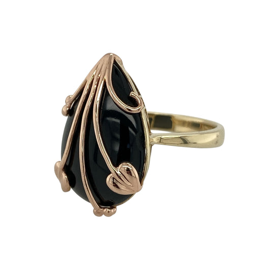 Bring bold elegance and meaningful symbolism to your collection with this pre-owned 9ct yellow and rose gold Clogau Tree of Life ring, featuring a striking black onyx centrepiece and iconic detailing—perfect for making a statement.

Design: The ring showcases a large teardrop-shaped black onyx measuring approximately 20mm by 13mm, beautifully framed with the signature Tree of Life motif for a bold and eye-catching look.