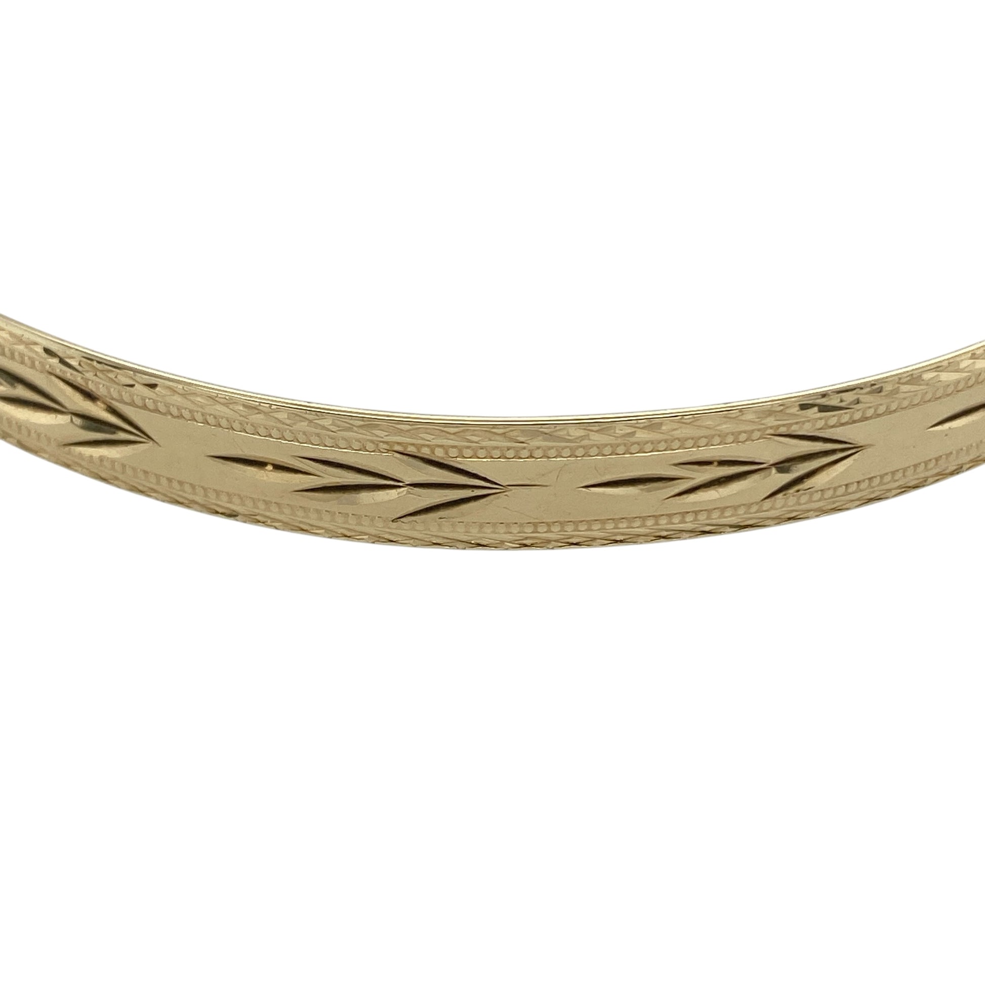 Bring timeless elegance and substantial style to your collection with this pre-owned 9ct yellow solid gold patterned bangle, featuring a classic design with intricate detail—perfect for everyday wear or special occasions.

Design: The bangle features a patterned finish across a 6mm wide profile, creating a decorative and light-catching look with timeless appeal.