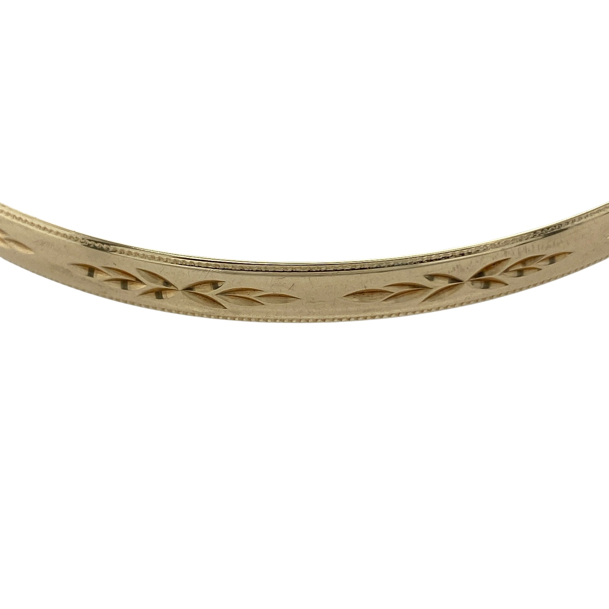 Bring timeless elegance and classic detail to your collection with this pre-owned 9ct yellow solid gold patterned bangle, featuring a refined design with everyday versatility—perfect for effortless styling or special occasions.

Design: The bangle features a patterned finish across a 5mm wide profile, creating a decorative and light-catching look with timeless appeal.