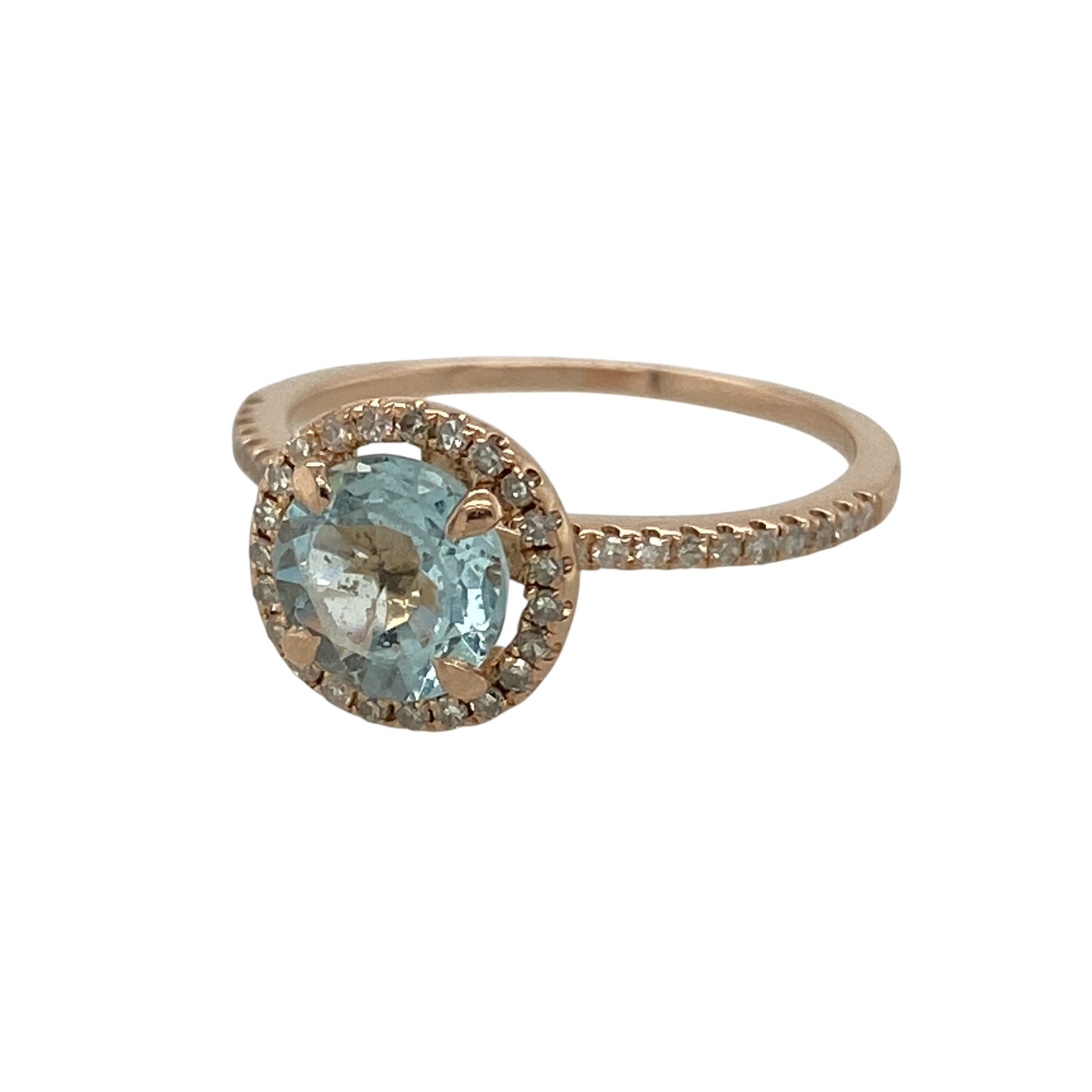 Bring soft colour and elegant sparkle to your collection with this pre-owned 14ct rose gold diamond and blue stone halo ring, featuring a refined design with romantic appeal—perfect for special occasions or everyday sophistication.

Design: The ring showcases an approximately 6.5mm round aquamarine-coloured blue stone at the centre, surrounded by a halo of sparkling diamonds with additional diamonds set along the shoulders for added brilliance.