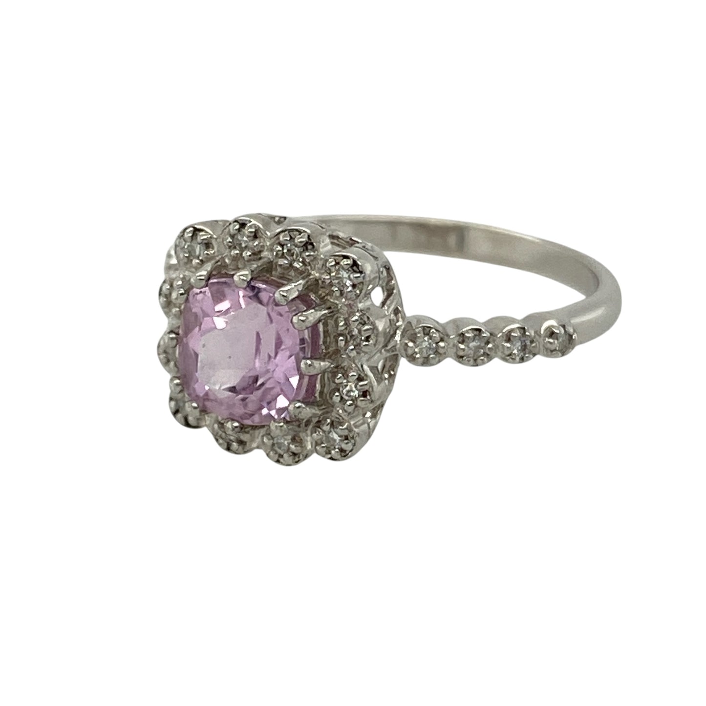 Bring feminine colour and elegant sparkle to your collection with this pre-owned 9ct white gold diamond and pink stone halo ring, featuring a sophisticated design with timeless appeal—perfect for special occasions or everyday glamour.

Design: The ring showcases a 6mm by 6mm cushion-cut pink stone at the centre, surrounded by a halo of sparkling diamonds with additional diamonds set along the shoulders for added brilliance and elegance.