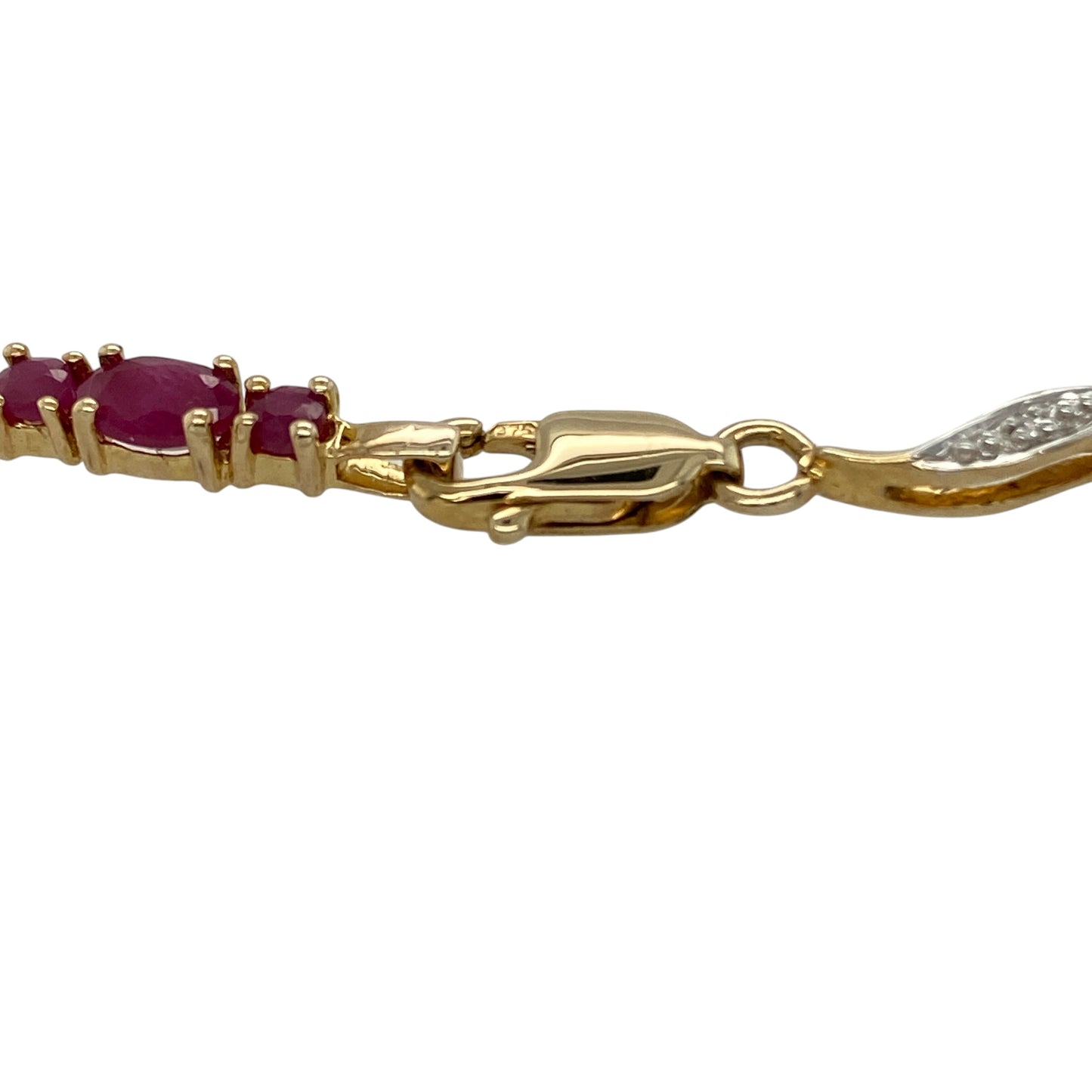 Bring rich colour and timeless elegance to your collection with this pre-owned 9ct yellow gold diamond and ruby set bracelet, featuring a beautifully detailed design with luxurious sparkle—perfect for special occasions or sophisticated everyday wear.

Design: The bracelet features a repeating three-ruby pattern, with a central ruby measuring approximately 5mm by 5mm flanked by two smaller rubies of approximately 2mm diameter each