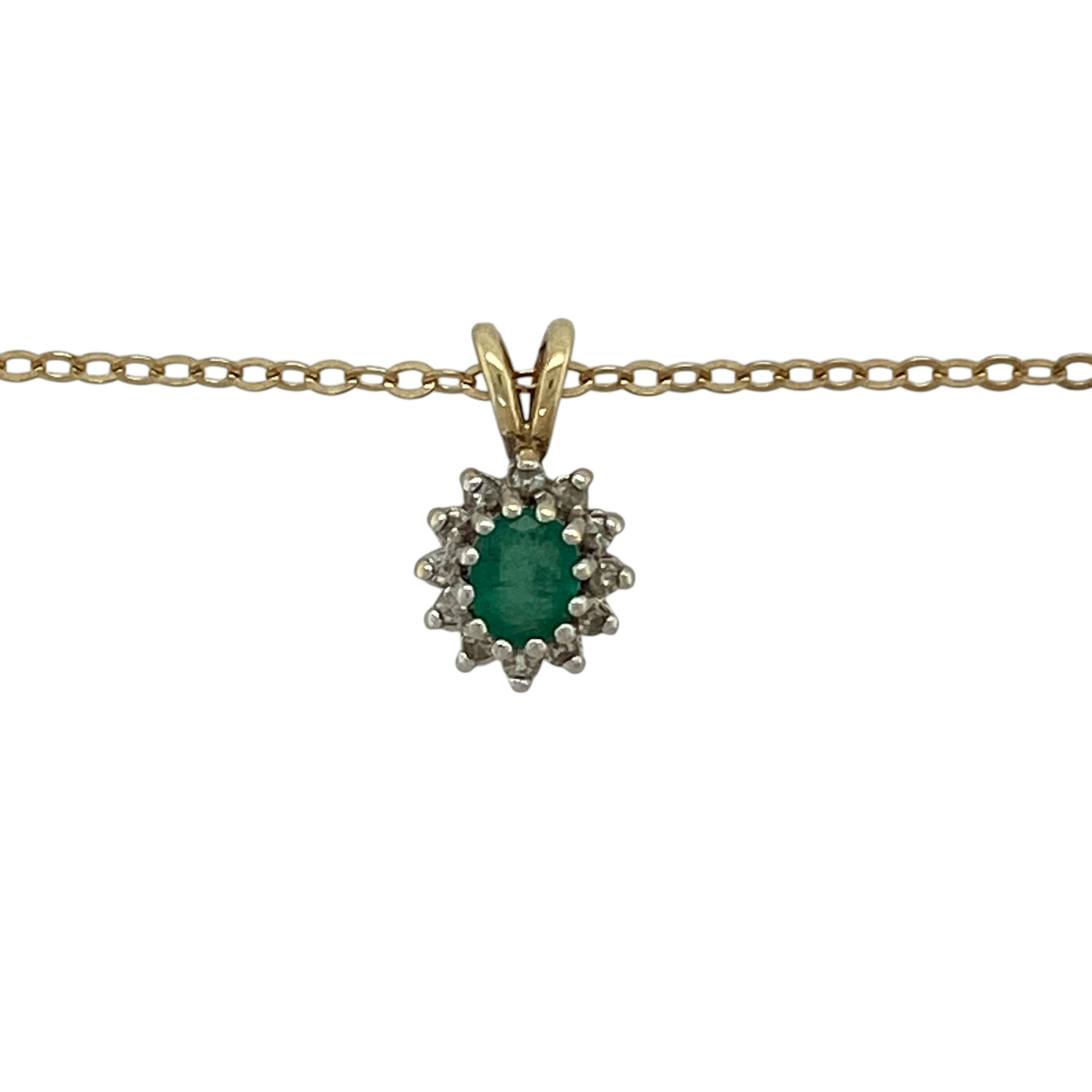 Bring timeless colour and elegant sparkle to your collection with this pre-owned 9ct yellow gold diamond and emerald cluster pendant necklace, featuring a classic design with refined detail—perfect for everyday wear or special occasions.

Design: The necklace features a cluster-style pendant measuring approximately 1.4cm in length including the bail, centred with an oval emerald measuring approximately 5mm by 4mm and surrounded by sparkling diamonds for added brilliance.