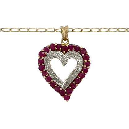 Bring romantic elegance and timeless sparkle to your collection with this pre-owned 9ct yellow gold diamond and ruby open heart pendant necklace, featuring a graceful design with meaningful appeal—perfect for everyday wear or a heartfelt gift.

Design: The necklace features an open heart pendant measuring approximately 2.8cm in length including the bail, accented with vibrant rubies and sparkling diamonds for a striking and feminine finish. The pendant is suspended from an 18" open curb chain.