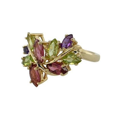 Bring vibrant colour and nature-inspired elegance to your collection with this pre-owned 9ct yellow gold gemstone leaf style ring, featuring a bold floral design with eye-catching detail—perfect for special occasions or statement everyday wear.

Design: The ring showcases an elaborate leaf-inspired design measuring approximately 1.9cm in height, set with marquise cut rubies, peridot, and amethyst stones arranged to create a colourful and flowing botanical effect.