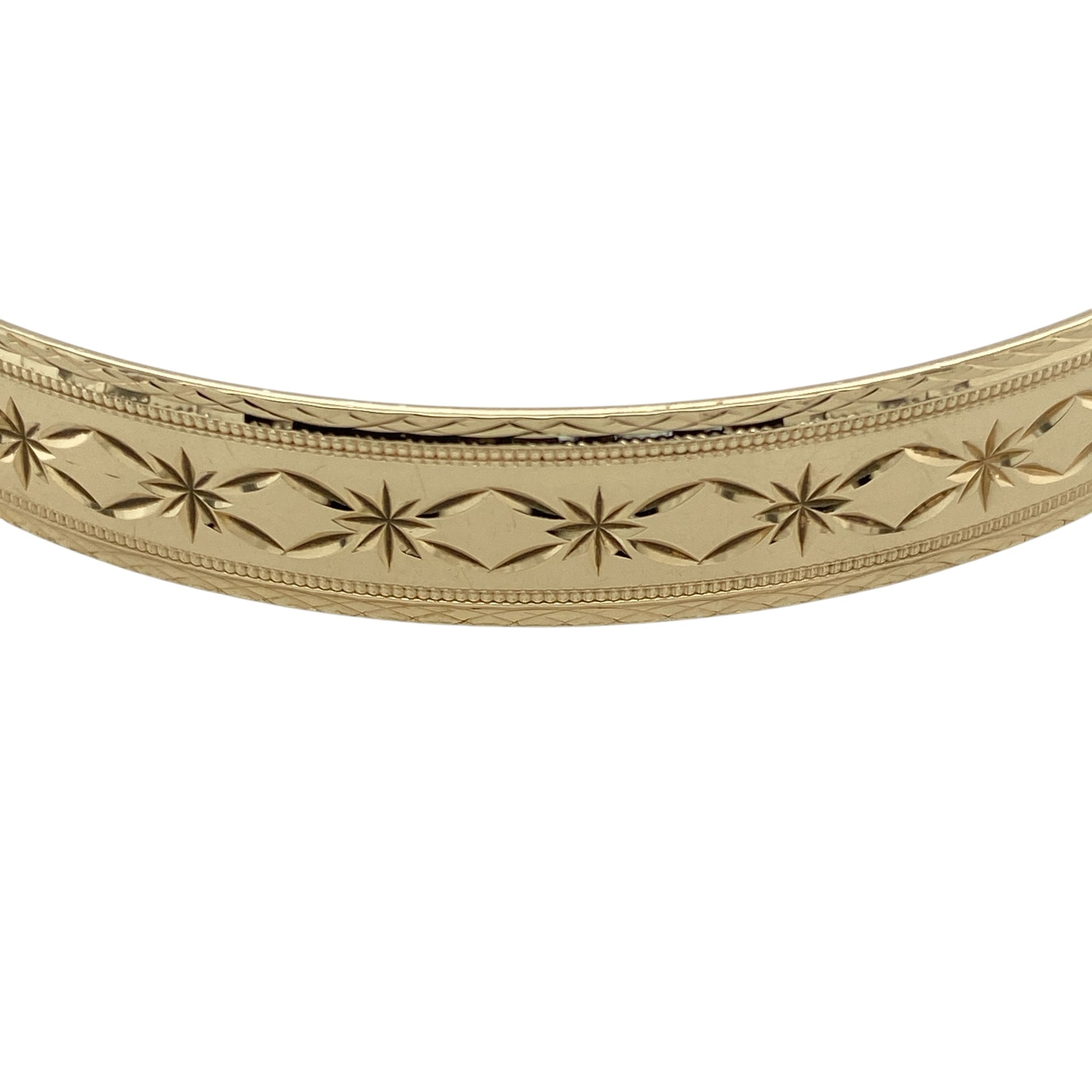 Add timeless elegance to your jewellery collection with this pre-owned 9ct yellow solid gold patterned bangle, featuring detailed decorative styling and a classic polished finish—perfect for everyday luxury, occasion wear, or stacking with other gold jewellery pieces.

Design: The bangle features an attractive patterned finish throughout, creating a stylish textured appearance with timeless appeal. Measuring approximately 9mm wide, the design offers a bold and elegant presence on the wrist.