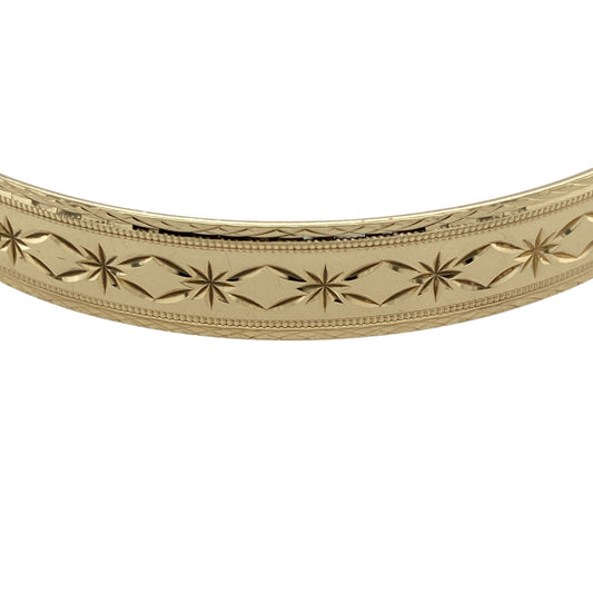 Add timeless elegance to your jewellery collection with this pre-owned 9ct yellow solid gold patterned bangle, featuring detailed decorative styling and a classic polished finish—perfect for everyday luxury, occasion wear, or stacking with other gold jewellery pieces.

Design: The bangle features an attractive patterned finish throughout, creating a stylish textured appearance with timeless appeal. Measuring approximately 9mm wide, the design offers a bold and elegant presence on the wrist.