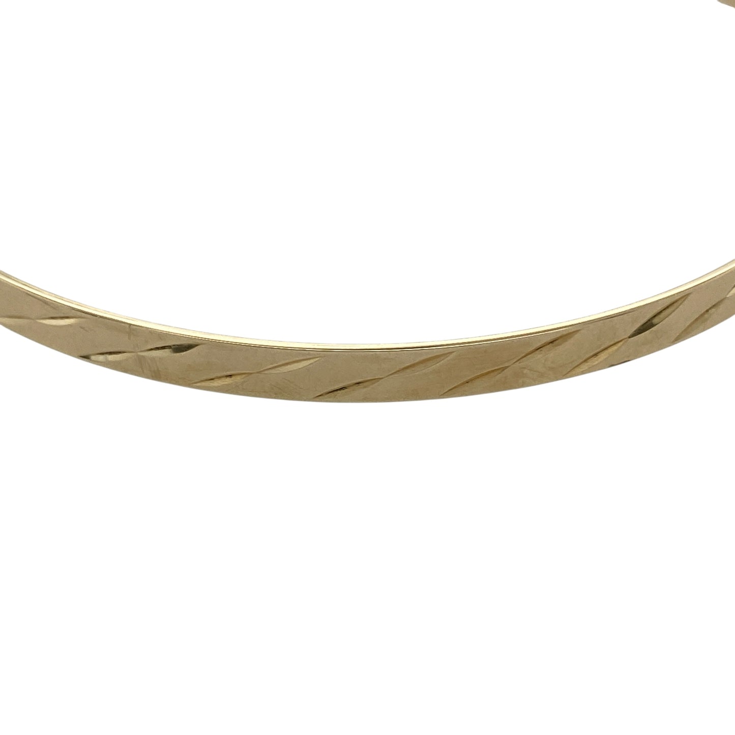 Add timeless elegance to your jewellery collection with this pre-owned 9ct yellow solid gold patterned bangle, featuring delicate decorative detailing and a classic slim profile—perfect for everyday wear, stacking, or understated occasion styling.

Design: The bangle features an attractive patterned finish throughout, creating a refined textured appearance with classic appeal. Measuring approximately 4mm wide, the slim design offers an elegant and versatile look suitable for any occasion.