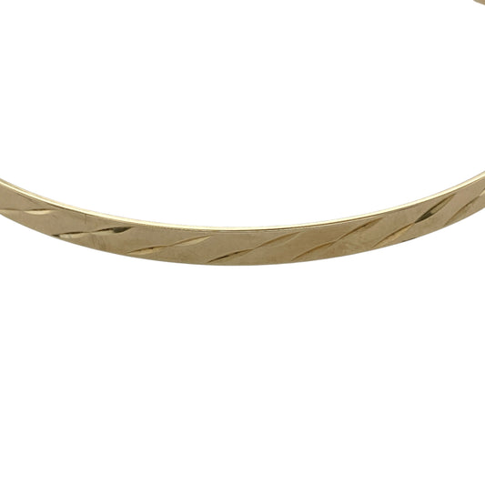 Add timeless elegance to your jewellery collection with this pre-owned 9ct yellow solid gold patterned bangle, featuring delicate decorative detailing and a classic slim profile—perfect for everyday wear, stacking, or understated occasion styling.

Design: The bangle features an attractive patterned finish throughout, creating a refined textured appearance with classic appeal. Measuring approximately 4mm wide, the slim design offers an elegant and versatile look suitable for any occasion.
