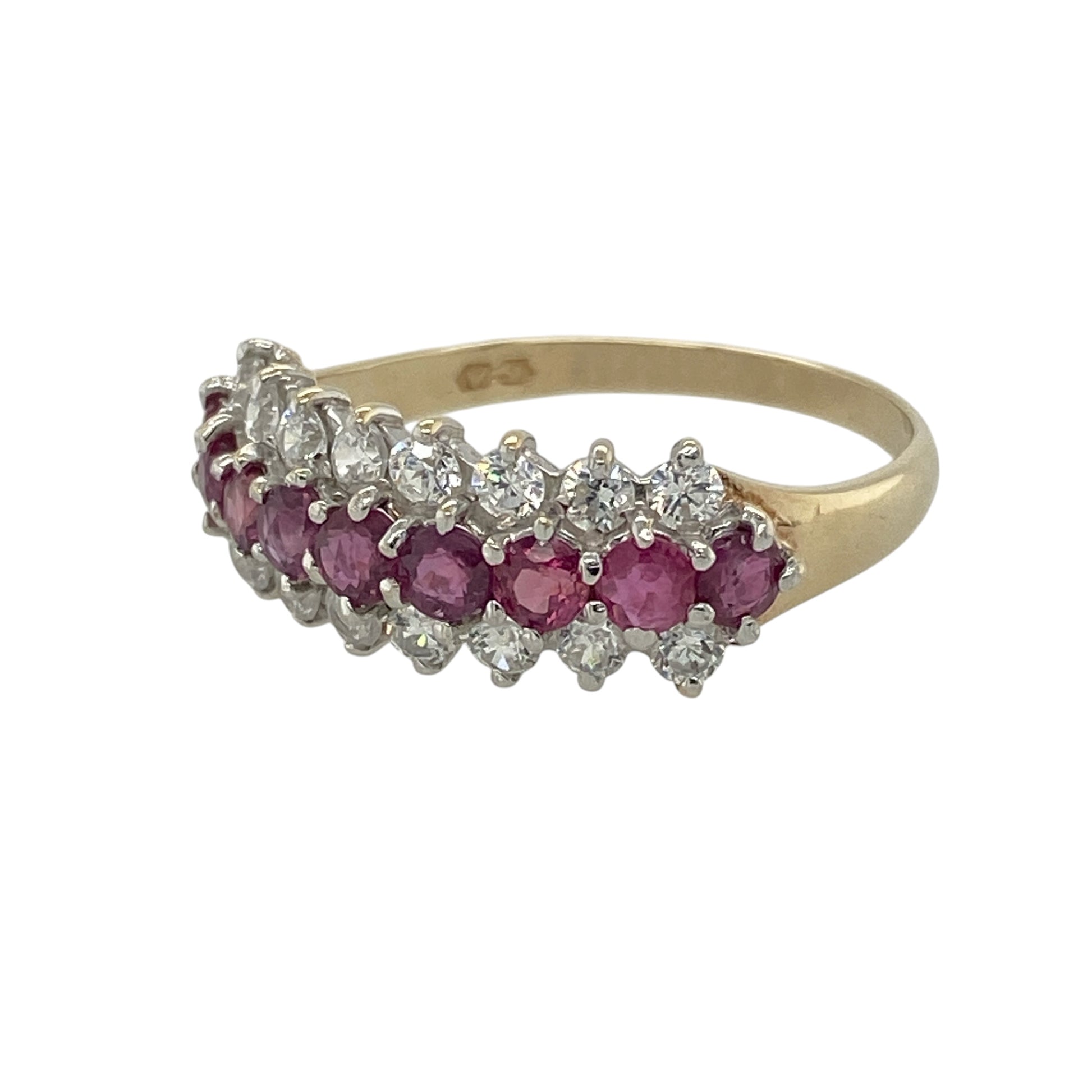 Add vibrant colour and elegant sparkle to your jewellery collection with this pre-owned 9ct yellow gold ruby and cubic zirconia three row band ring, featuring a striking multi-row design with timeless appeal—perfect for special occasions, evening wear, or adding a touch of luxury to everyday styling.

Design: The ring features an eye-catching three row band design with rich ruby stones measuring approximately 3mm in diameter, complemented by sparkling 2mm cubic zirconia stones for added brilliance.