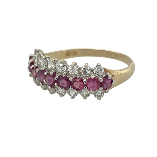 Add vibrant colour and elegant sparkle to your jewellery collection with this pre-owned 9ct yellow gold ruby and cubic zirconia three row band ring, featuring a striking multi-row design with timeless appeal—perfect for special occasions, evening wear, or adding a touch of luxury to everyday styling.

Design: The ring features an eye-catching three row band design with rich ruby stones measuring approximately 3mm in diameter, complemented by sparkling 2mm cubic zirconia stones for added brilliance.