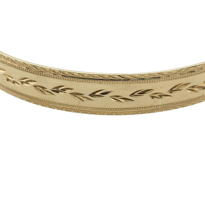 Add timeless elegance to your jewellery collection with this pre-owned 9ct yellow solid gold patterned bangle, featuring detailed decorative styling and a classic polished finish—perfect for everyday luxury, occasion wear, or stacking with other gold jewellery pieces.

Design: The bangle features an attractive patterned finish throughout, creating a stylish textured appearance with timeless appeal. Measuring approximately 9mm wide, the design offers a bold and elegant presence on the wrist.
