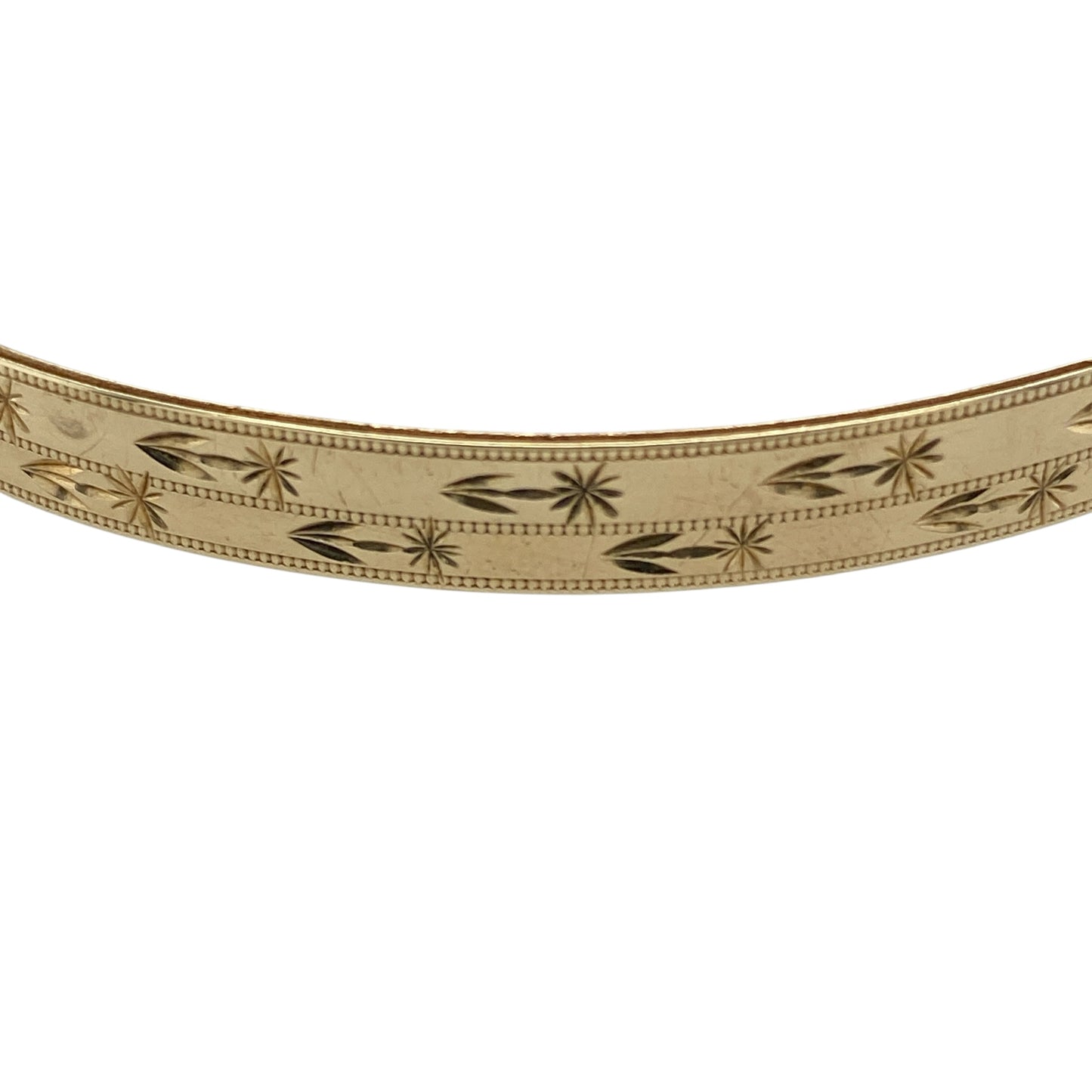 Add timeless elegance to your jewellery collection with this pre-owned 9ct yellow solid gold patterned bangle, featuring classic decorative detailing and a refined polished finish—perfect for everyday wear, occasion styling, or stacking with other gold jewellery pieces.

Design: The bangle features an attractive patterned finish throughout, creating a stylish textured appearance with timeless appeal. Measuring approximately 6mm wide, the design offers a refined yet noticeable presence on the wrist.